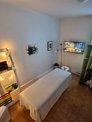 Massage Room A room with a massage table in the center, a clean professional look but has a cozy atmosphere.